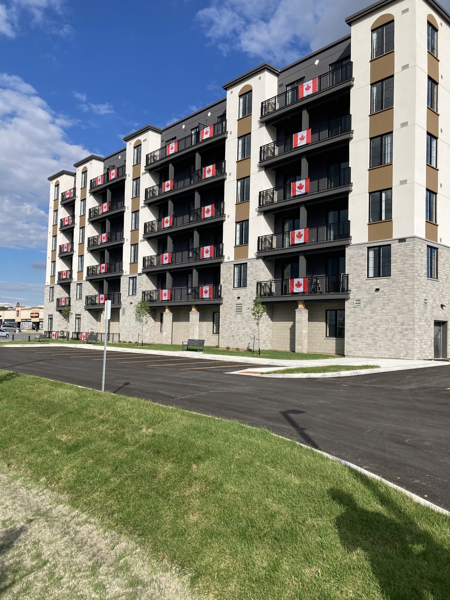 Kemptville Lifestyles building exterior with Canadian flags on balconies